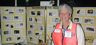 Nancy with descriptions of cats ready for adoption