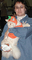 Chris Buck holds JoAnn Payfer's Maine Coon while JoAnn is busy costuming her Tonks.